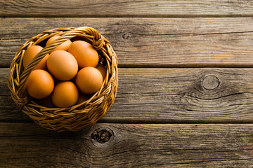 basket of eggs on old wooden background