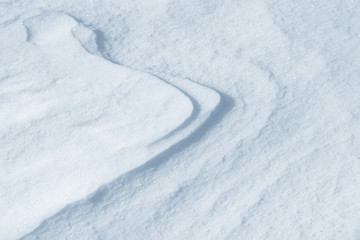 Fresh snow background texture. Winter background with snowflakes and snow mounds. Snow lumps.