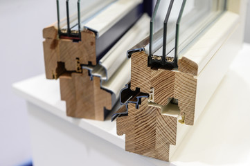 Obraz premium demonstration elements of a two-chamber plastic and wooden window to the consumer Sample showing the workmanship and the principle of operation of the product