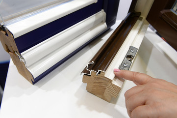 demonstration of opening and closing of plastic and wooden windows on a sample of profiles....