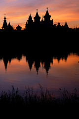 Fototapeta na wymiar Silhouette of the castle and its reflection in the lake at sunset