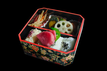 Square japanese bento box with rice and vegetables, isolated on black background