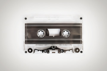 Translucent audio cassette tape on white background