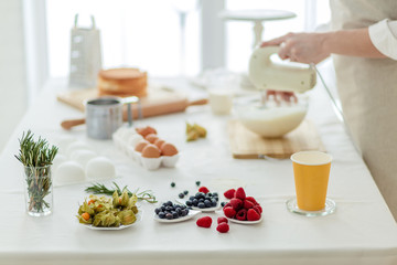 table with yummy different kinds of berries ,blurred background, focus on berries, close up image