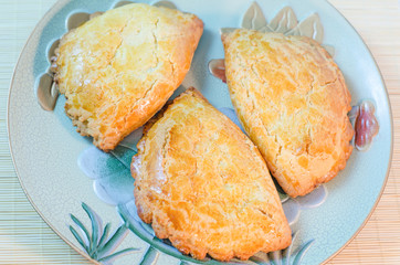 Homemade pastries with cottage cheese on a large plate.