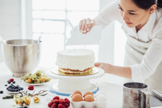 cake decorating tips. close up photo. woman practising cooking cake