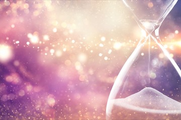 Sand running through the bulbs of an hourglass
