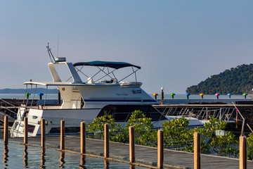Blue sea with white boat near a tropical hotel