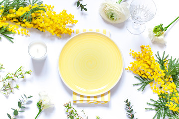 Spring floral table settings with spring flowers. Top view empty plate. Flat lay card. Copy space
