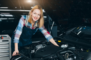 Plakat positive charming woman standing under the hood. close up photo. beauty concept. female labor