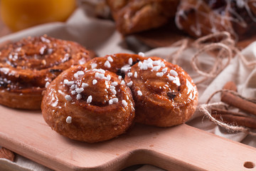 Fresh pastries for Breakfast on a wooden Board. Wooden background