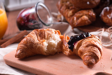 Fresh pastries for Breakfast on a wooden Board. Wooden background