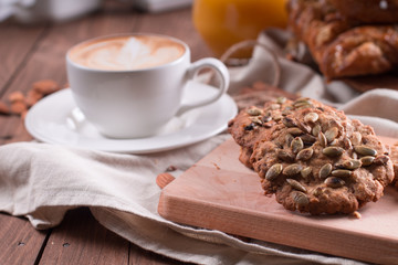 Oatmeal vegetarian cookies with pumpkin seeds. Wooden background