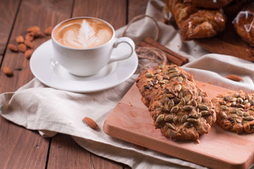 Oatmeal vegetarian cookies with pumpkin seeds. Wooden background