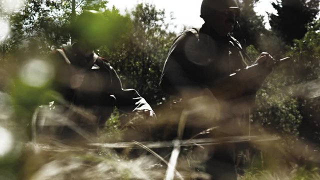 Soldiers walk through wilderness area