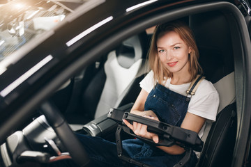 lovely girl testing client's car, close up photo, business concept