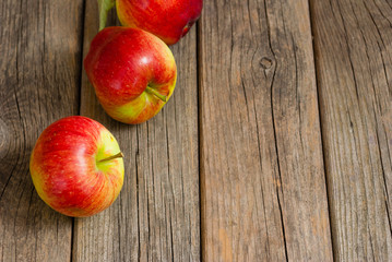 three apples on old wooden background