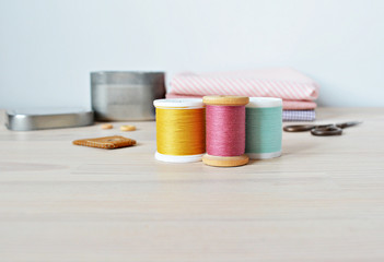 Colorful thread spoolss on the wooden table