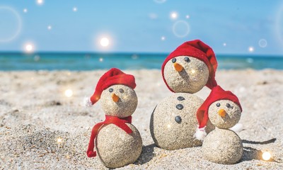 Sandy snowmen. Holiday concept can be used for New Year's and Christmas Card