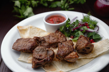 Shish kebabs on a white plate