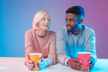 happy cheerful young diverse people enjoying time with each other, isolated blue background, studio shot, relationship, date, closeness, feeling, emotion - Powered by Adobe