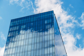 Sky with clouds reflect from glass wall of modern business center in Voronezh