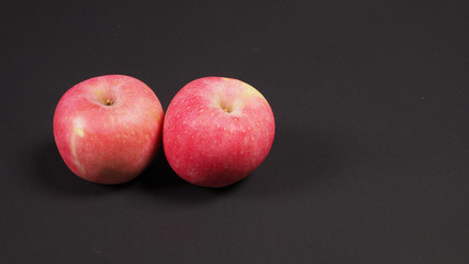 Fototapeta na wymiar Pink apple or Ambrosia Apple on BLACK background.