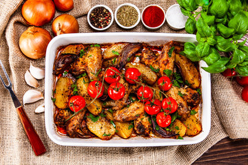 Grilled chicken wings with baked potatoes and vegetables