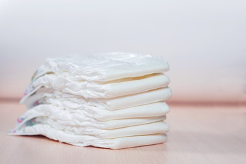 The pack of white children's diapers lies on a table