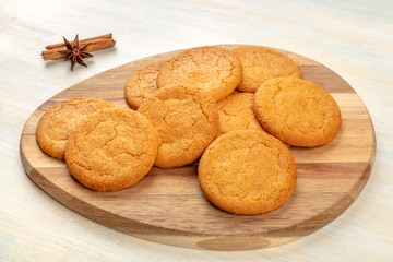 Ginger cookies on a wooden tray, with cinnamon and anise, selective focus