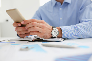 businessman holds a new smartphone in his hand