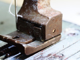 The photo of putting thread to a needle.