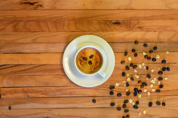Coffee cup and coffee beans with oats on wooden background. Top view.