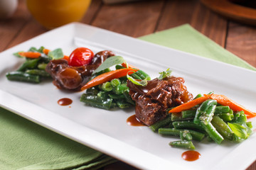 Beef steak with vegetables. Barbecue meat beef tenderloin. wooden background