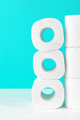 Toilet paper rolls on turquoise bright background