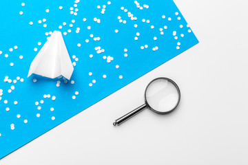 paper plane with office supplies on blue background