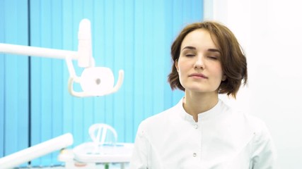 Closeup portrait of intellectual woman in white labcoat, looking at full body x-ray radiographic image, ct scan in the hospital. Young doctor looking at mri in medical cabinet.