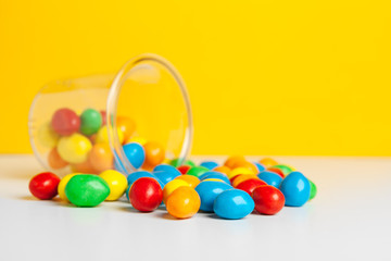 Bottles with sweet candies on table