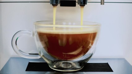 Coffee machine pouring coffee in the cup.