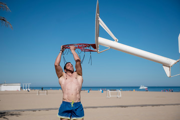 Attractive man doing sport on the beach
