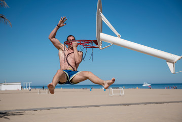 Attractive man doing sport on the beach