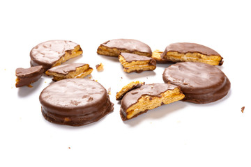 chocolate outer biscuits with broken sections on white background