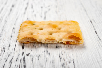 cross section of crispy cracker on white wood background