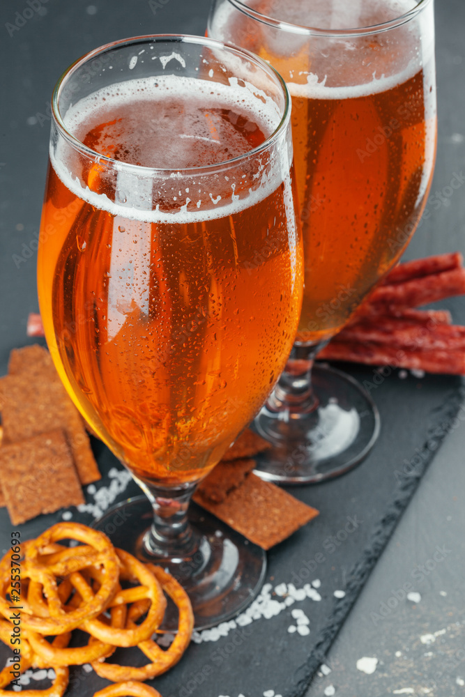 Wall mural  beer and appetizing beer snacks set. Table with mug of beer, wooden board with sausages