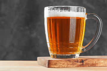 Single beer glass close up on dark stone background