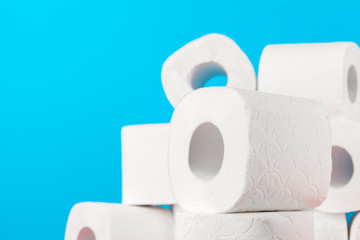 Toilet paper stack on bright blue background