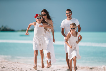 Young family of four on vacation have fun