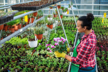 Black woman working in a botanical garden