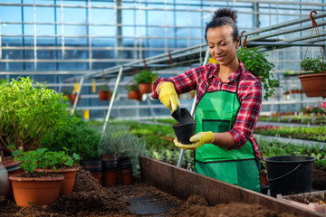 Black woman working in a botanical garden