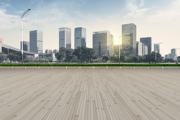 Naklejka premium Urban skyscrapers with empty square floor tiles